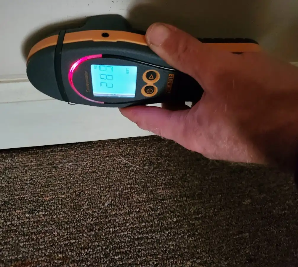 Moisture detection at baseboard during Storm Damage Restoration in Millburn